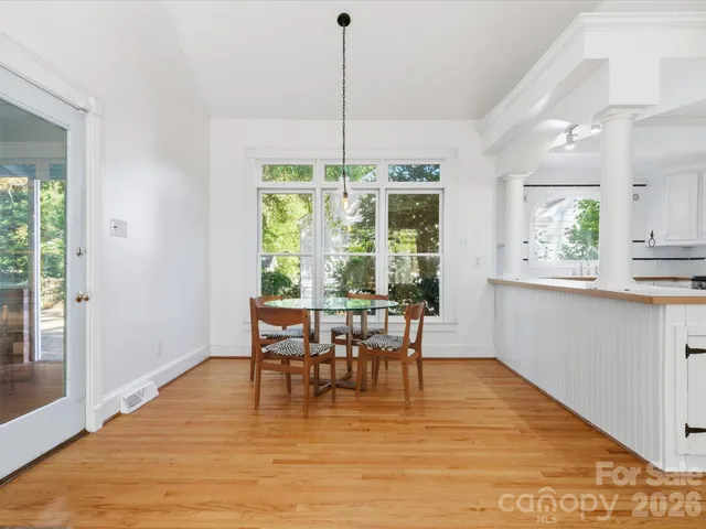 a view of a dining room with furniture window and wooden floor