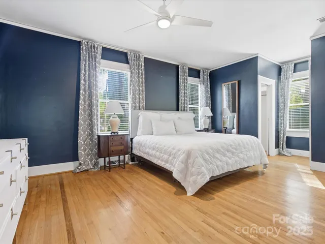 a bedroom with a bed and a mirror