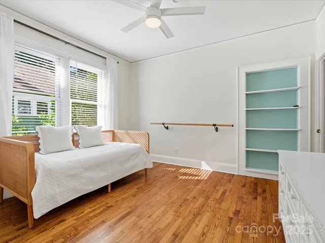 a living room with a bed furniture and a window