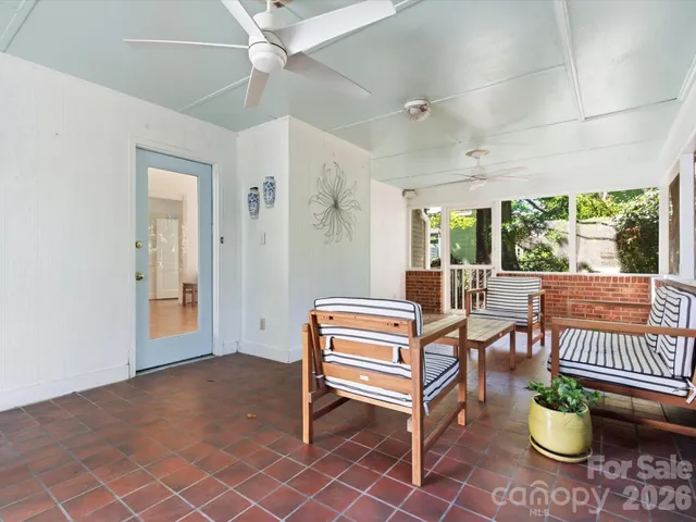 a living room with furniture a piano and a table