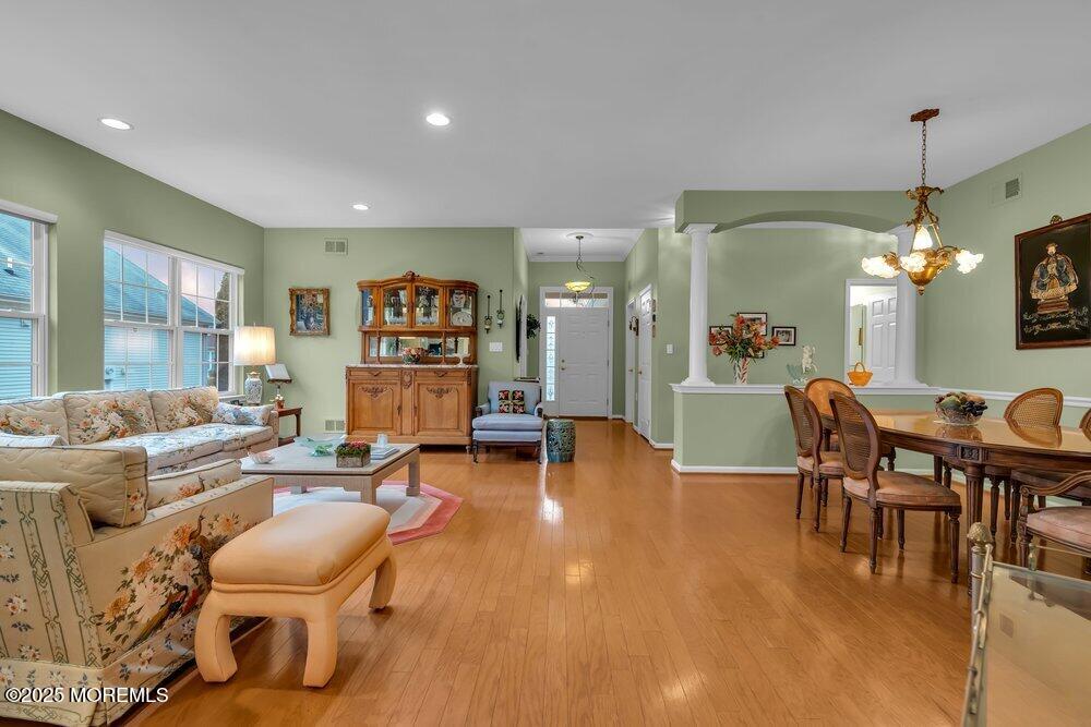 a living room with furniture a dining table and a large window