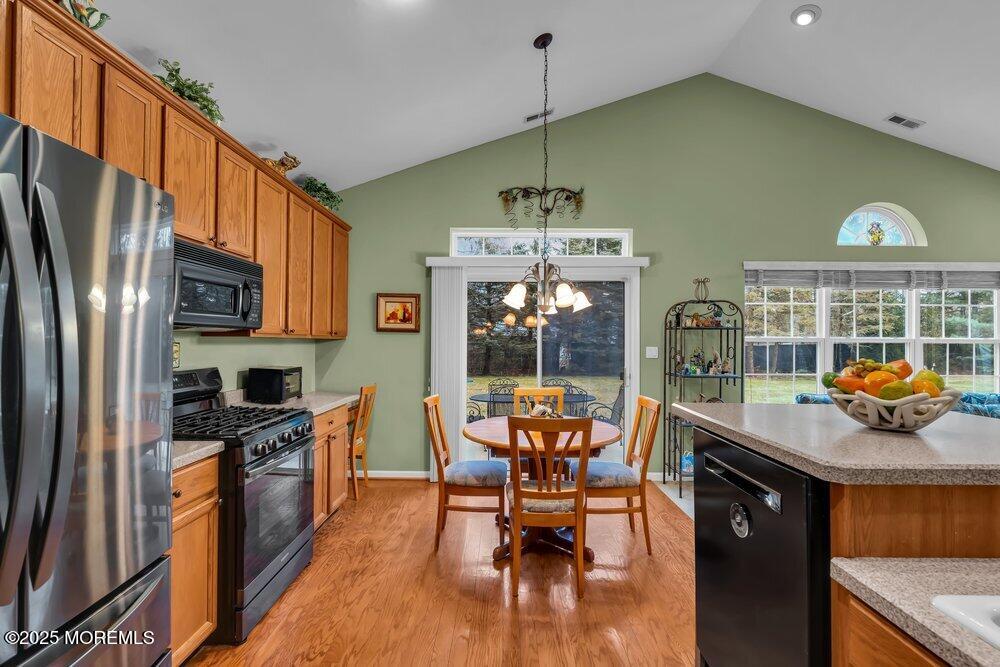 54 Drayton Road Manchester Township, NJ 08759 - Photo 29 of 93 a kitchen with stainless steel appliances a table chairs and a refrigerator