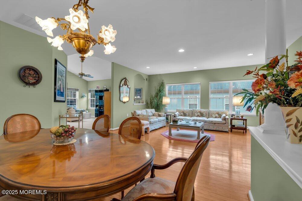 54 Drayton Road Manchester Township, NJ 08759 - Photo 5 of 93 a dining room with wooden floor a chandelier a wooden table and chairs