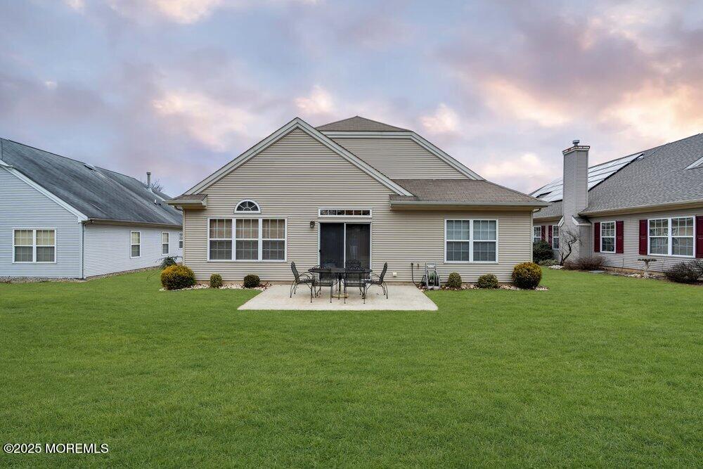 54 Drayton Road Manchester Township, NJ 08759 - Photo 57 of 93 a front view of a house with a yard patio and fire pit