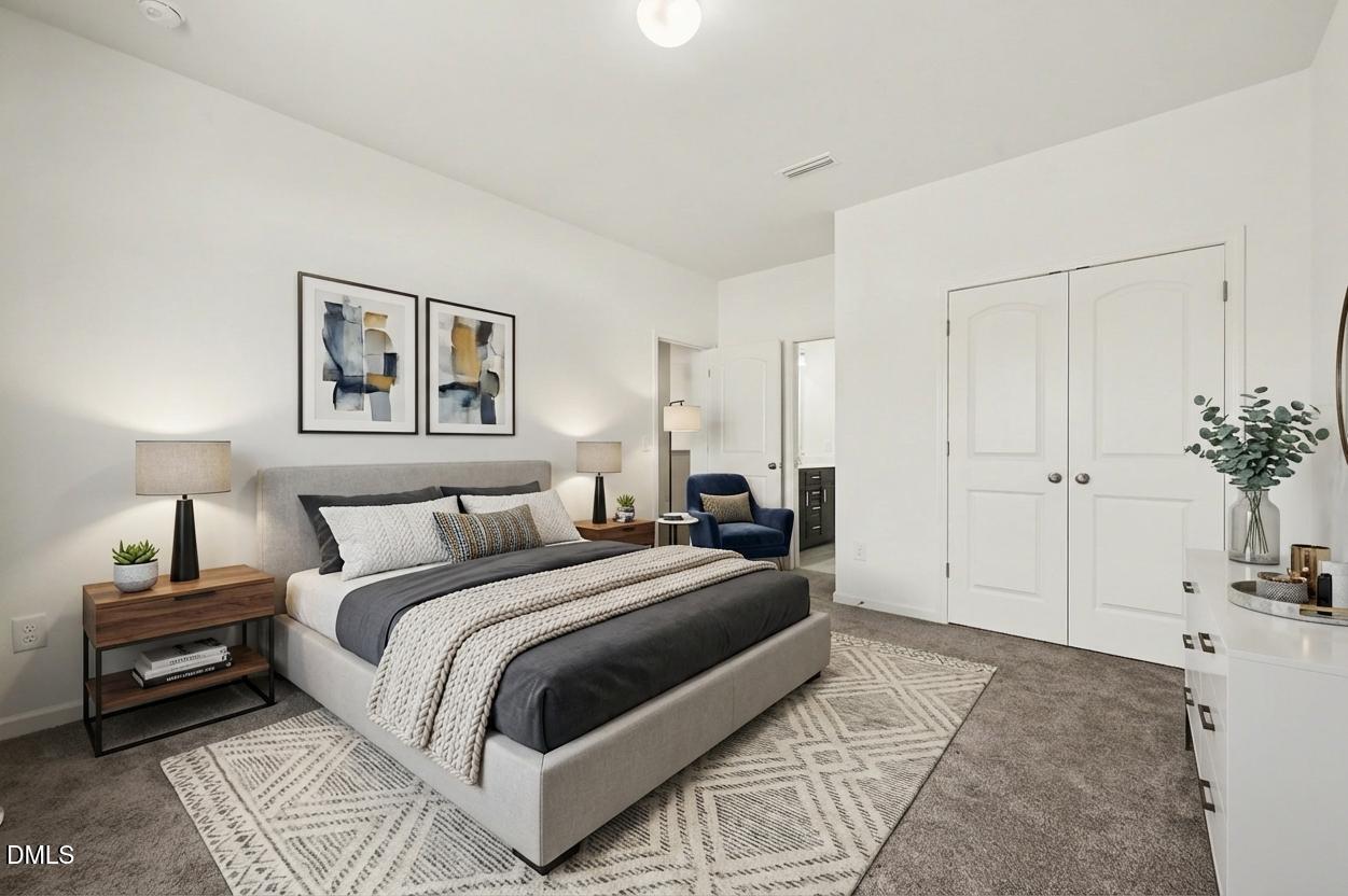 7015 Grainfield Road Mebane, NC 27302 - Photo 23 of 42 a bedroom with a large bed and a chandelier