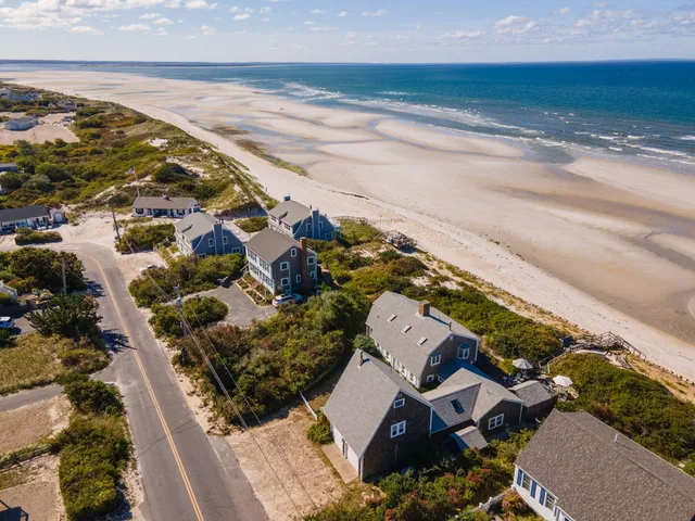 an aerial view of residential houses with outdoor space