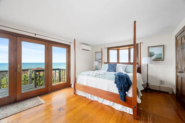 a bedroom that has a bed and a table in it