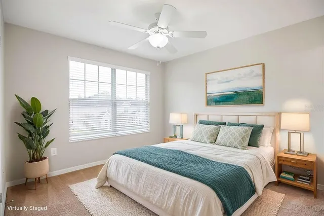 an empty room with chandelier fan and windows