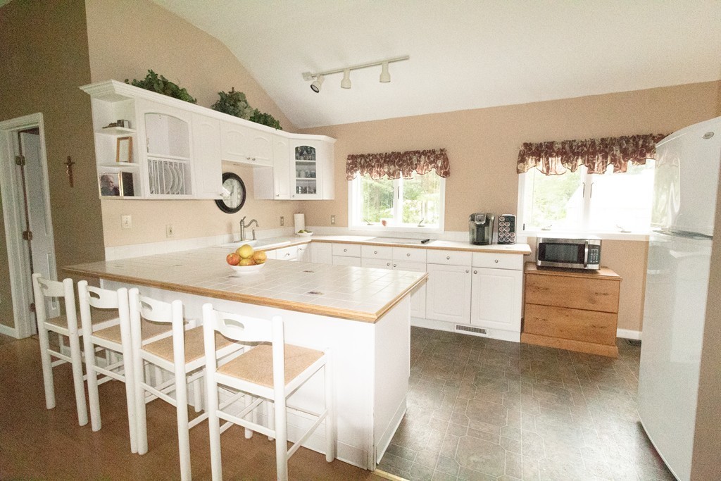 44 Flint Road Tyngsborough, MA 01879 - Photo 8 of 29 a kitchen with a sink stove and cabinets