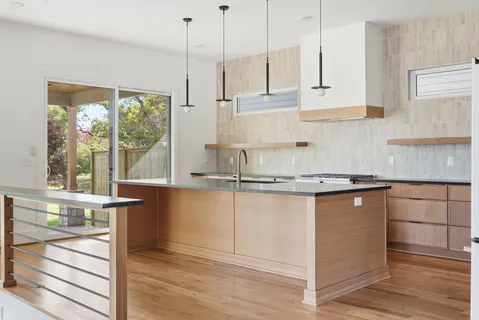 a kitchen with a sink window and cabinets