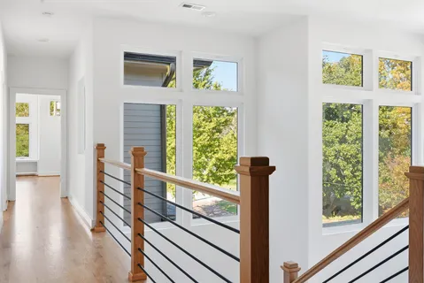 a view of a room with wooden floor and windows