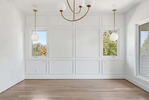a view of a room with wooden floor and window