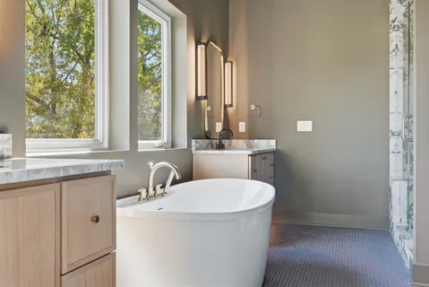 a bathroom with a sink a mirror and a window