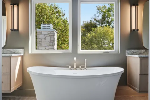 a bathroom with a bathtub and window
