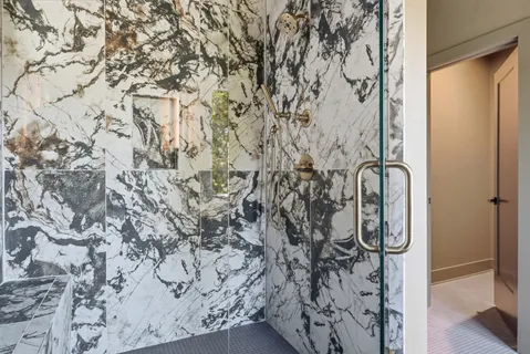 a bathroom with a shower curtain and a window