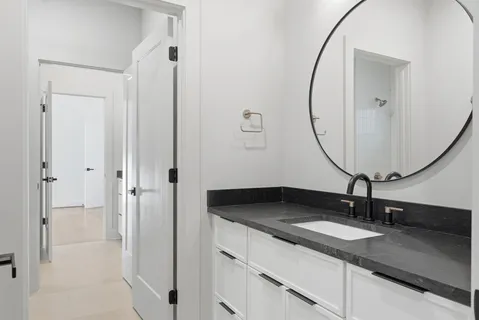 a sink with a mirror and vanity