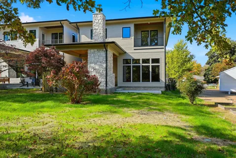 an aerial view of a house with a swimming pool yard and outdoor seating