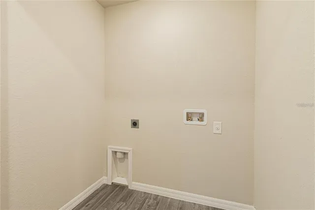 a view of a small space with wooden floor and a window