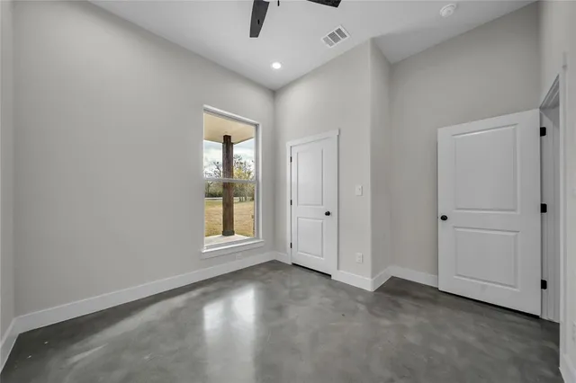 an empty room with windows and closet