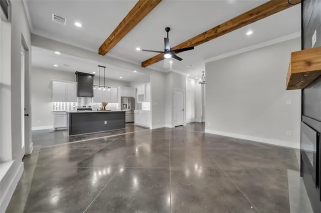 a view of kitchen and kitchen with stainless steel appliances wooden floor