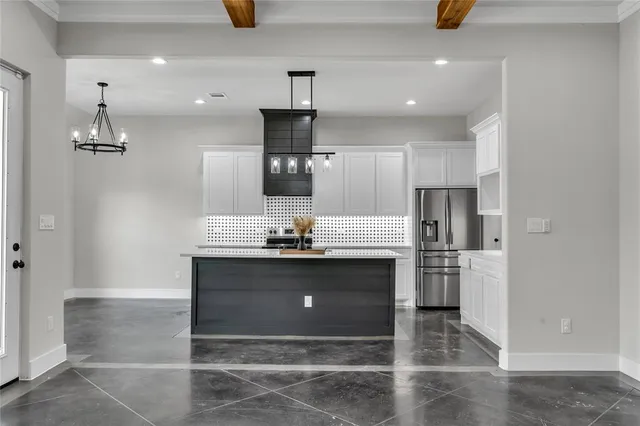 a kitchen with refrigerator and window