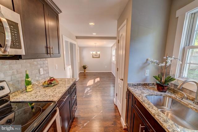 6 Dogwood Road Riva, MD 21140 - Photo 2 of 25 a kitchen with granite countertop stainless steel appliances a sink stove and cabinets