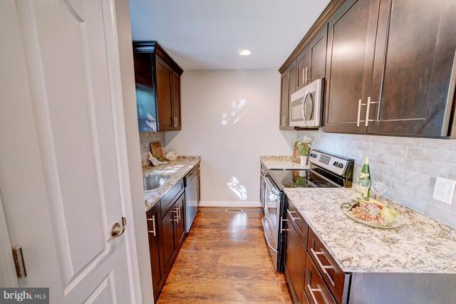 6 Dogwood Road Riva, MD 21140 - Photo 3 of 25 a kitchen with granite countertop stainless steel appliances and wooden cabinets