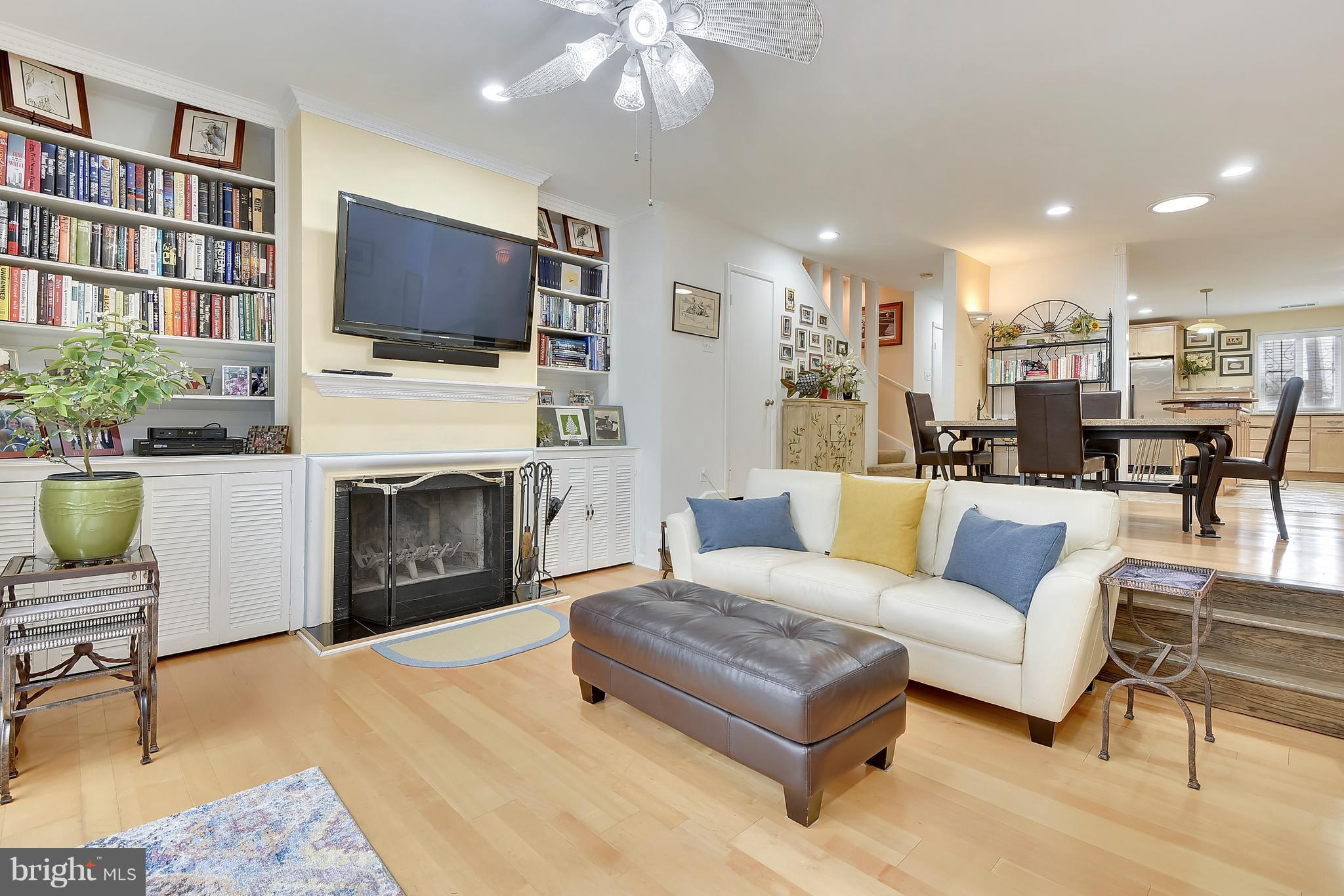 309 Fourth Street Annapolis, MD 21403 - Photo 3 of 30 a living room with furniture a flat screen tv and a fireplace