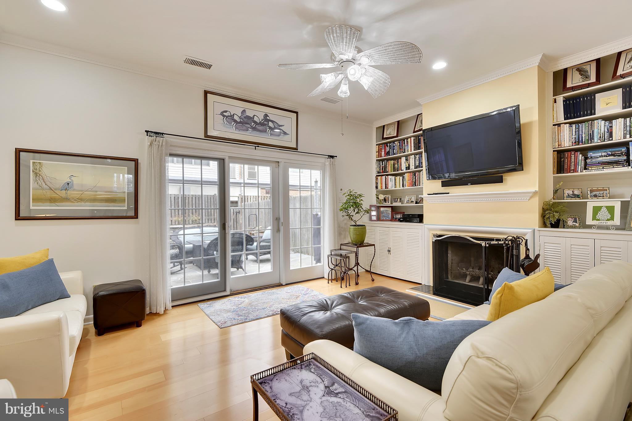 309 Fourth Street Annapolis, MD 21403 - Photo 4 of 30 a living room with furniture a flat screen tv and a fireplace