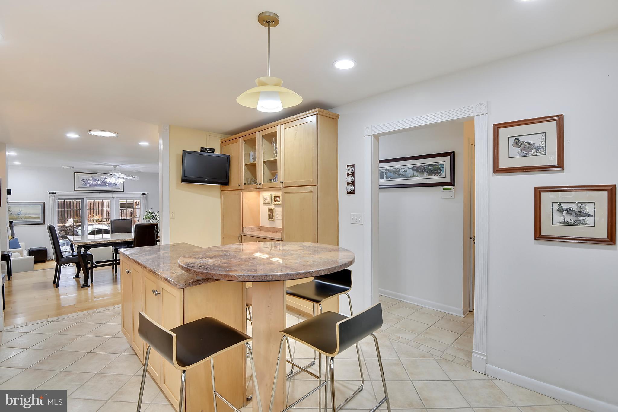 309 Fourth Street Annapolis, MD 21403 - Photo 7 of 30 a kitchen with stainless steel appliances kitchen island granite countertop a table chairs and a refrigerator