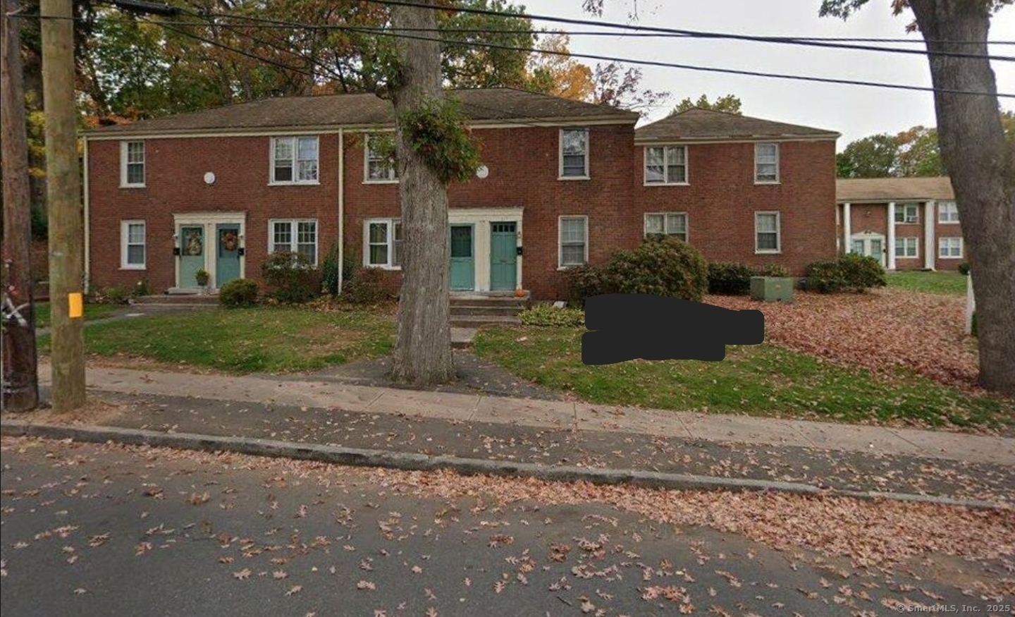 a view of a brick building next to a yard