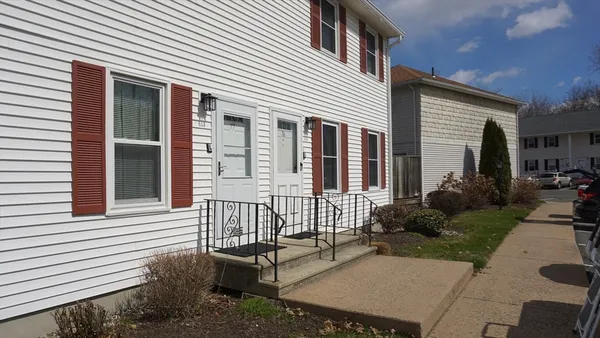 a view of a house with backyard and sitting area