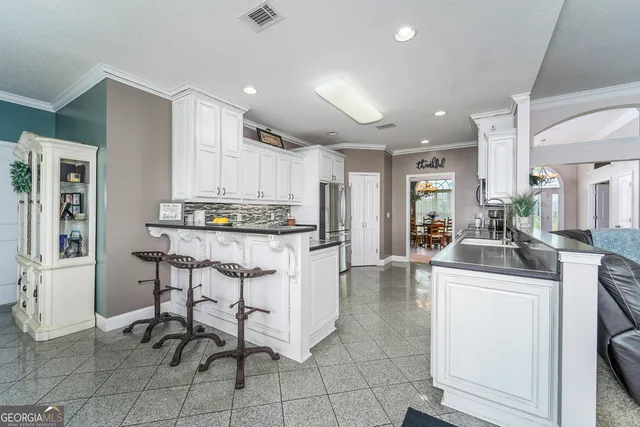 a kitchen with a sink and a potted plant