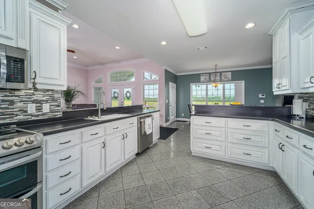 a kitchen with white cabinets and white appliances