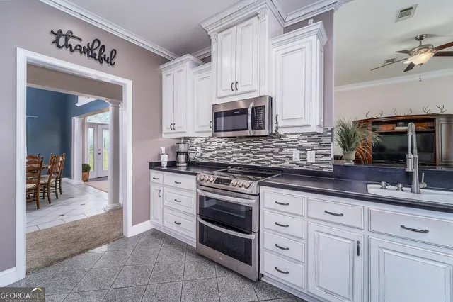 a spacious bedroom with a bed and a chandelier