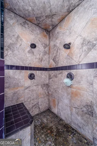 a bathroom with a sink mirror and shower