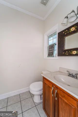 a bedroom with a bed and a potted plant