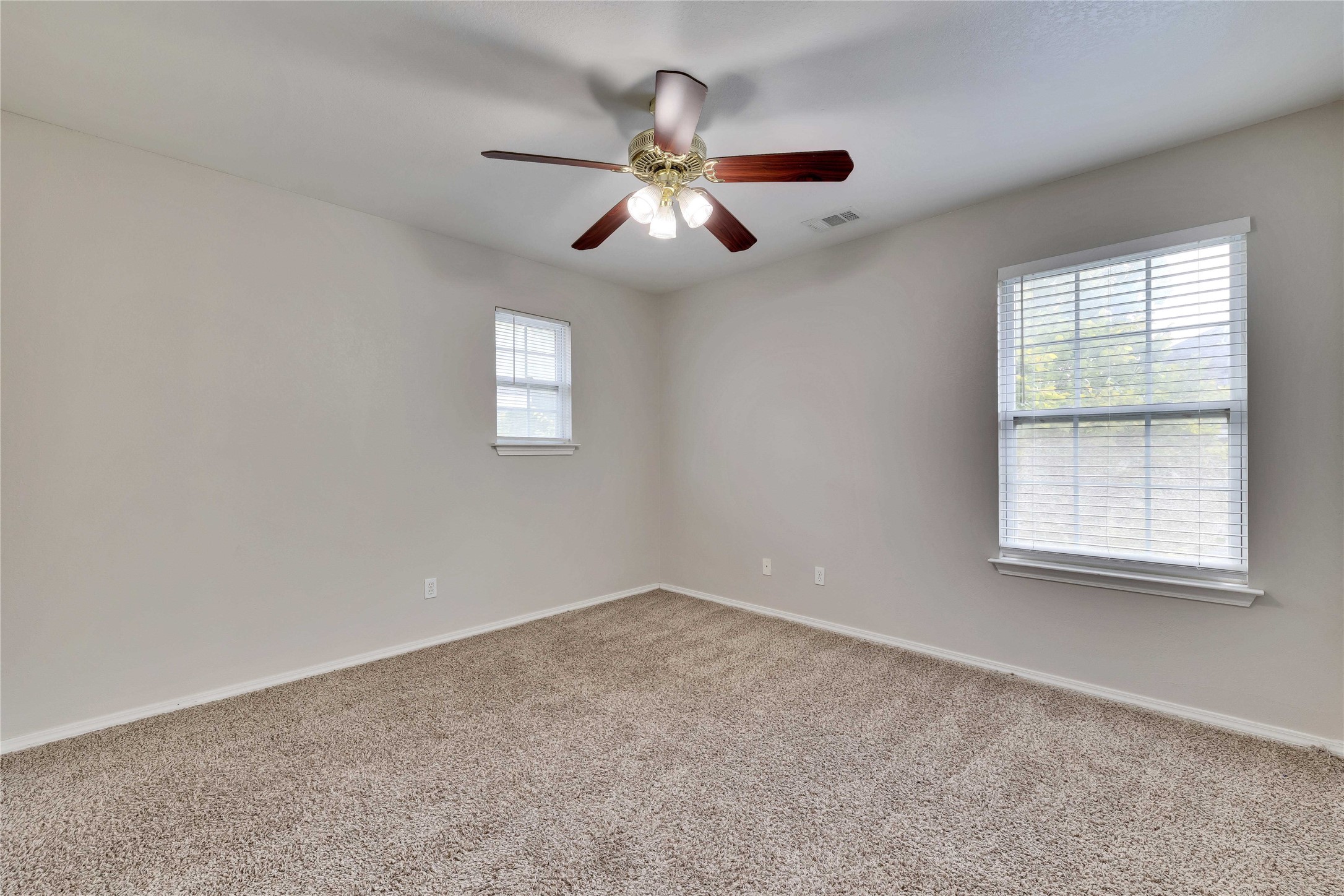 2201 East 18th Street, Unit B Austin, TX 78702 - Photo 16 of 25 A well-lit bedroom features plush carpeting and multiple windows for abundant natural light.