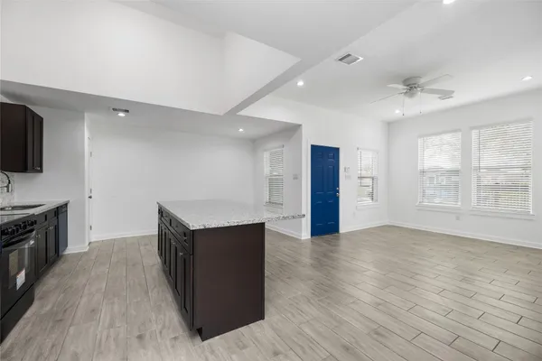 a kitchen with stainless steel appliances granite countertop a sink stove and microwave