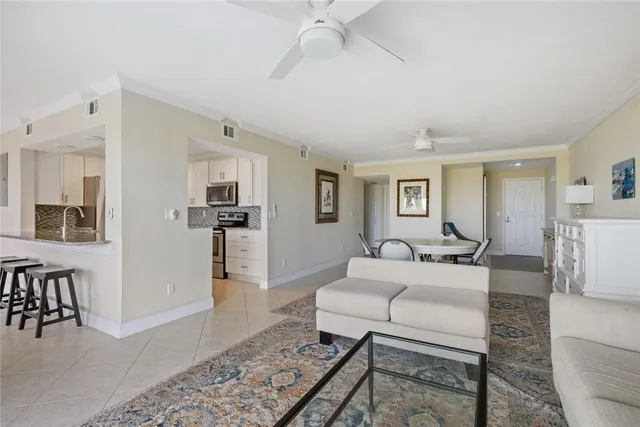 a kitchen with granite countertop white cabinets and stainless steel appliances
