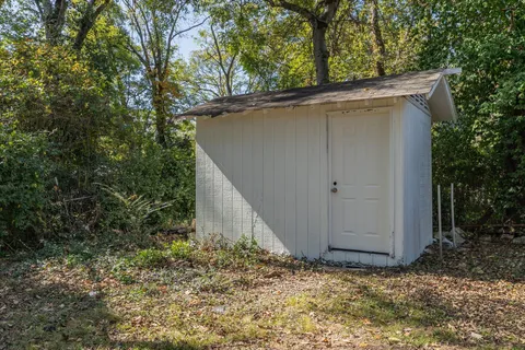 a view of backyard of house with green space