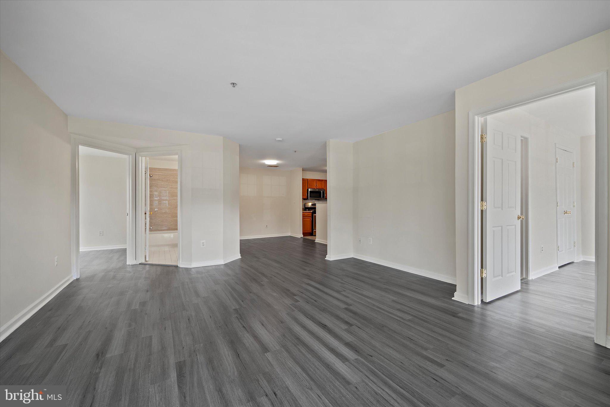 8083 Lacy Drive, Unit 101 Manassas, VA 20109 - Photo 12 of 31 a view of empty room with wooden floor