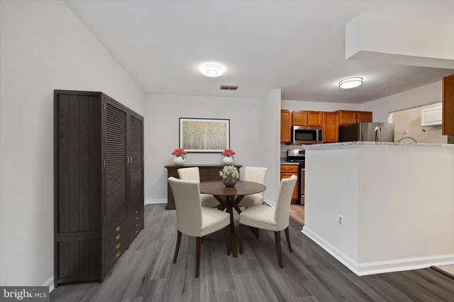 a dining room with furniture and wooden floor