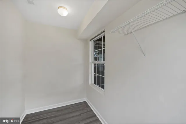 a view of a room with wooden floor