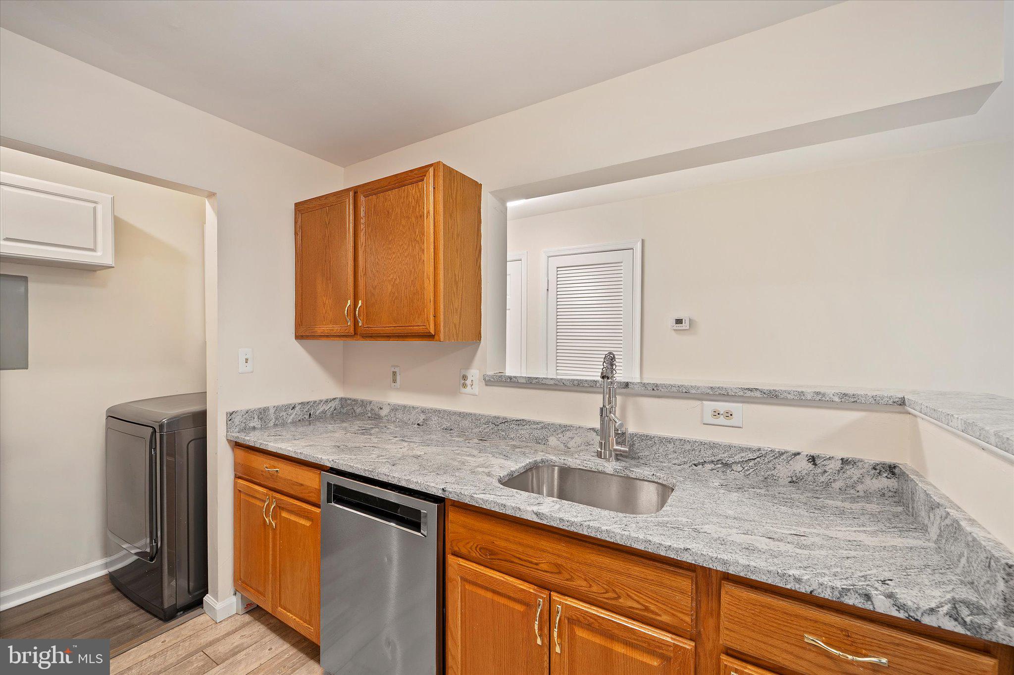 8083 Lacy Drive, Unit 101 Manassas, VA 20109 - Photo 4 of 31 a kitchen with stainless steel appliances granite countertop a sink and a white cabinets