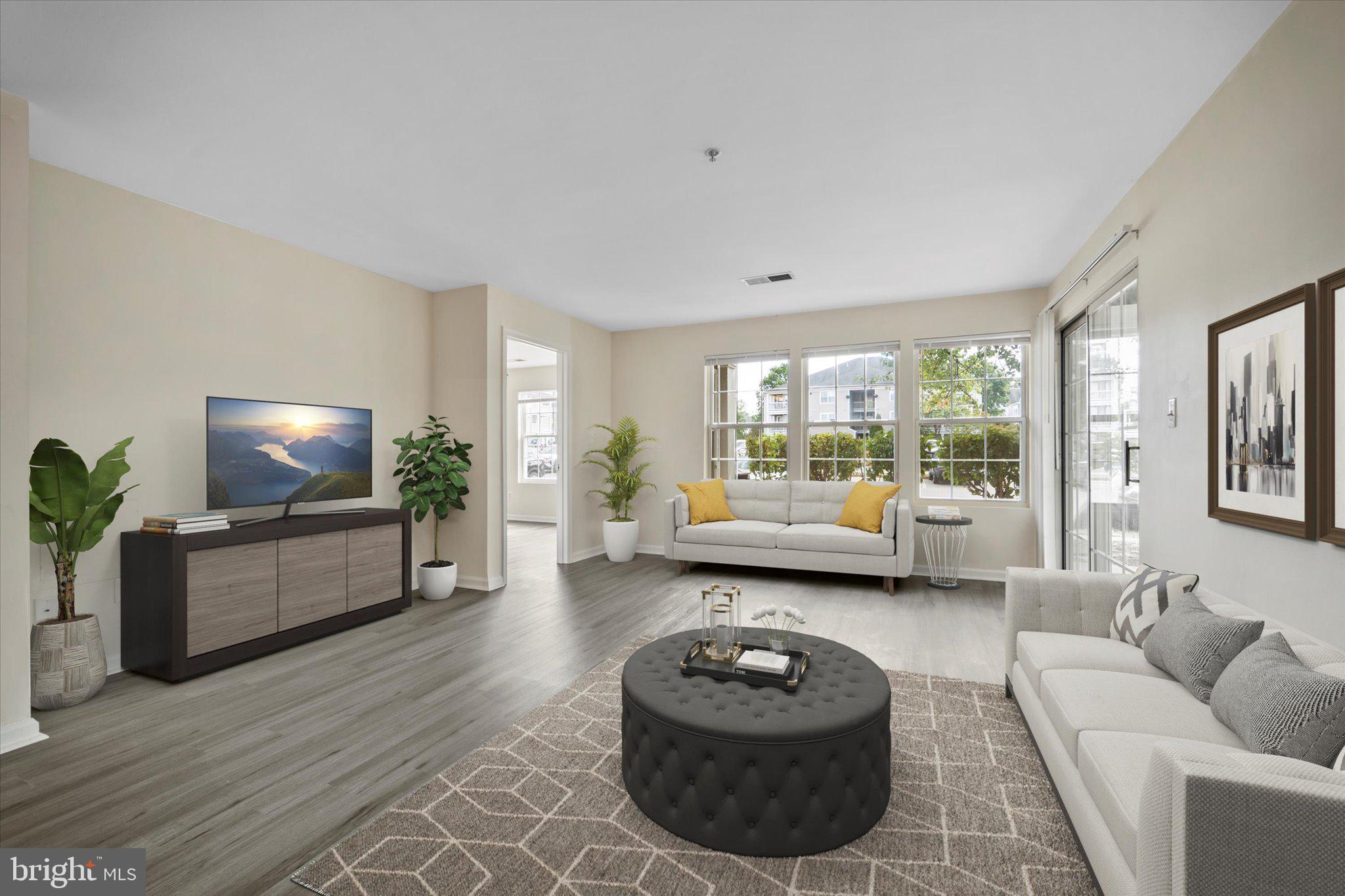 8083 Lacy Drive, Unit 101 Manassas, VA 20109 - Photo 6 of 31 a living room with furniture and a flat screen tv