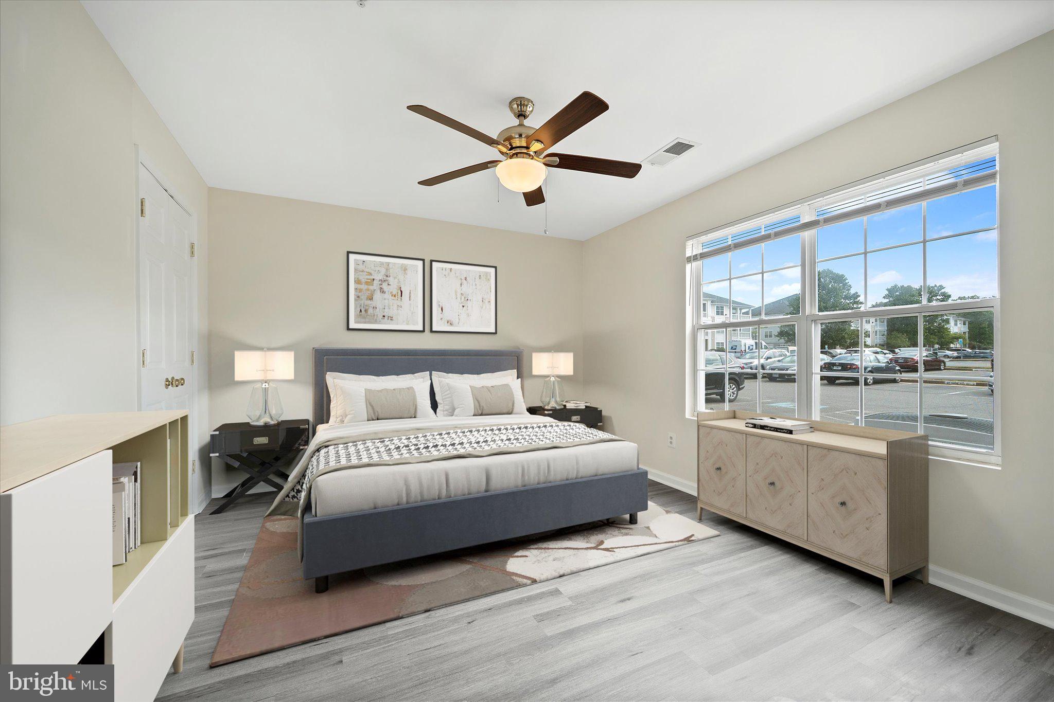 8083 Lacy Drive, Unit 101 Manassas, VA 20109 - Photo 8 of 31 a spacious bedroom with a large bed and a chandelier fan