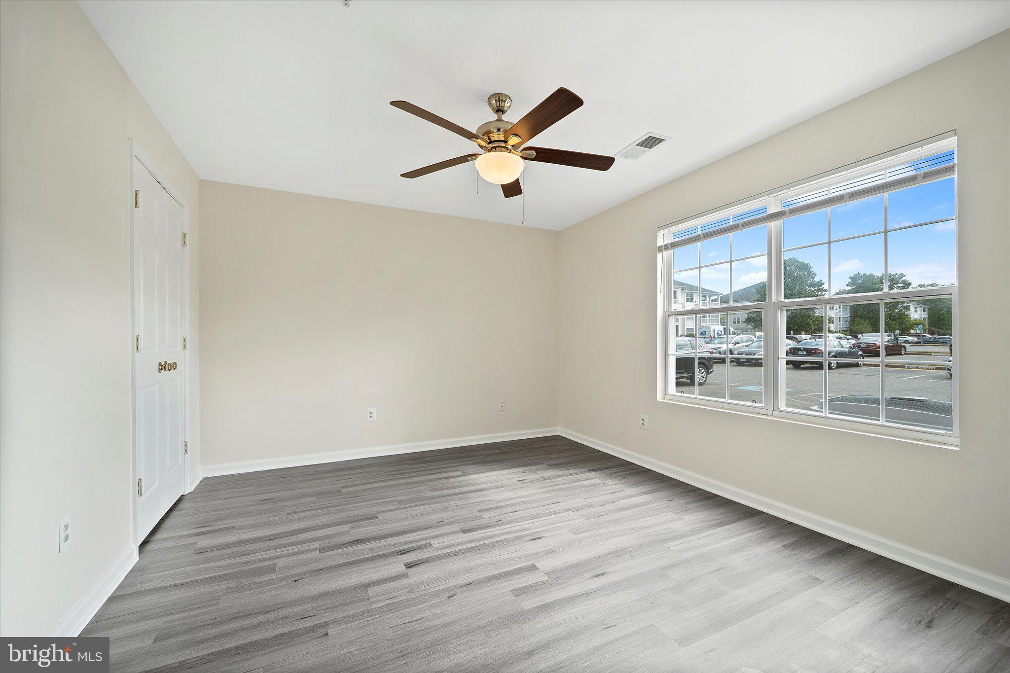 8083 Lacy Drive, Unit 101 Manassas, VA 20109 - Photo 9 of 31 a view of a big room with wooden floor and windows