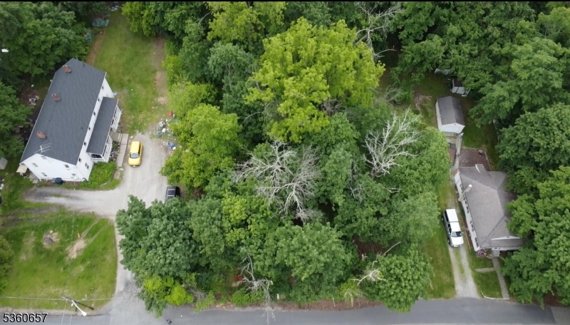 an aerial view of a house with a yard and lake view