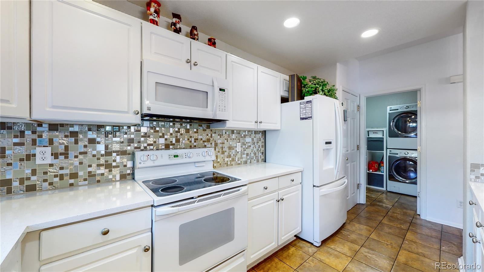 10105 North Grove Loop, Unit A Westminster, CO 80031 - Photo 11 of 40 a kitchen with cabinets appliances and a counter space